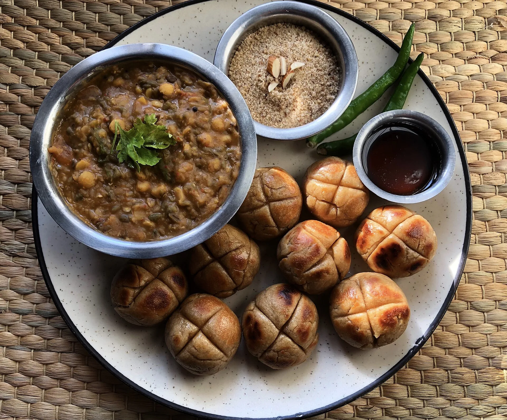 Dal, baati and churma served together on a plate