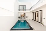 Calisto: Pool courtyard beneath the white villa exterior