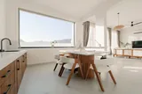 Calisto: Kitchen and dining area with warm wooden finishes