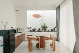 Elara: Wooden dining table beside the kitchenette