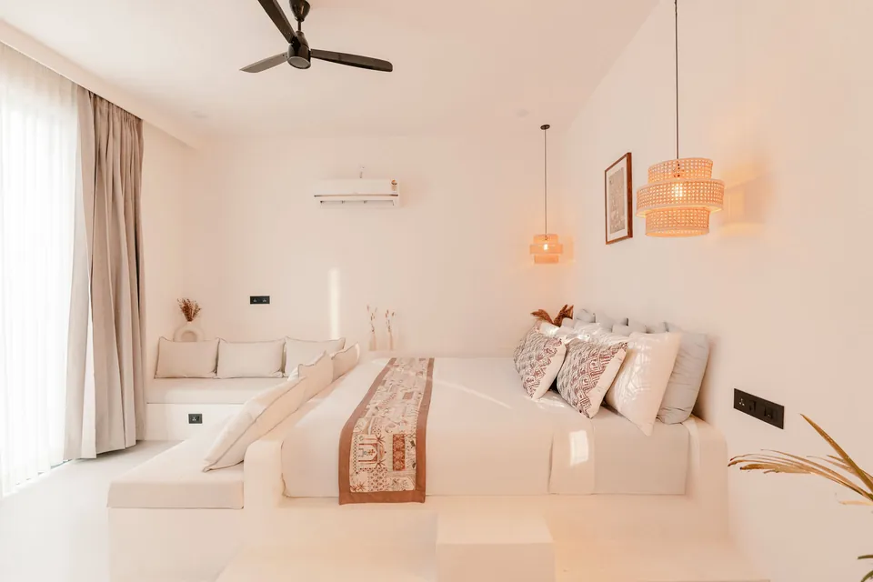 Elara bedroom with a woven headboard and sofa
