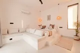 Elara: Bedroom with pendant lights and natural textures